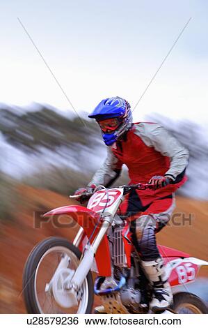 Download Young man motocross over field. Stock Photograph ...