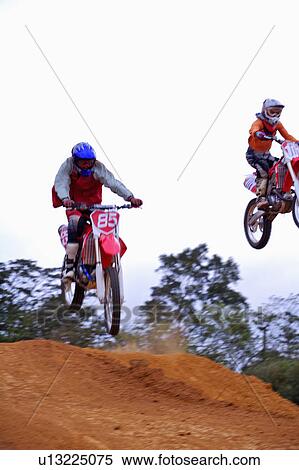 Stock Photography - Young man motocross over field.. Fotosearch