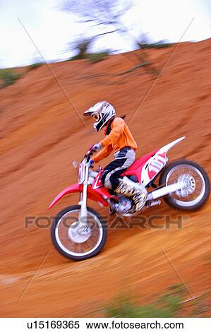 Stock Photography - Young man motocross over field.. Fotosearch