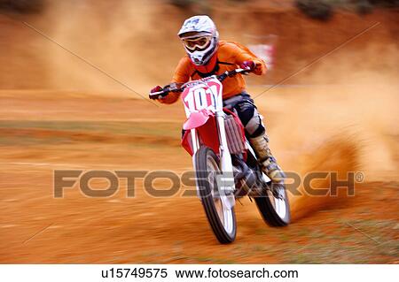 Stock Photography - Young man motocross over field.. Fotosearch