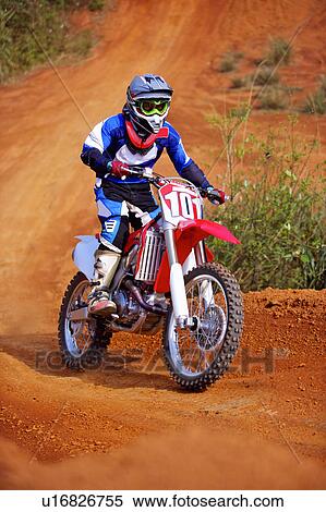 Stock Photography - Young man motocross over field.. Fotosearch