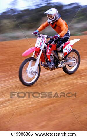 Stock Photography - Young man motocross over field.. Fotosearch