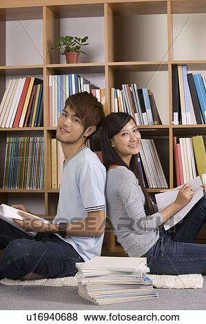 Schoolboy and schoolgirl sitting together with back to back View Large Photo Image Stock Photo - Schoolboy and schoolgirl sitting together with back to back. Fotosearch