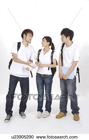 Stock Image - Schoolboys and schoolgirl discussing together. Fotosearch