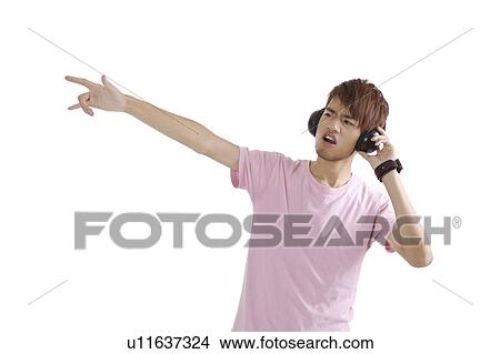 "Teenager boy dancing and listening music, portrait" View Large Photo Image Picture - "Teenager boy dancing and listening music, portrait". Fotosearch