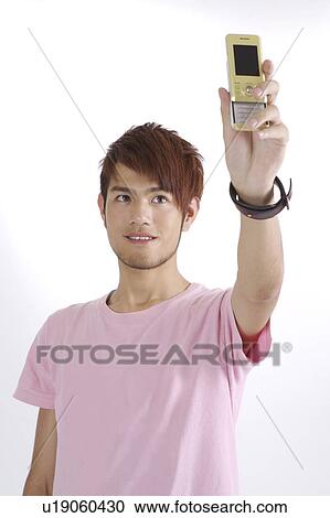 "Teenager boy doing photo messaging and looking up, portrait" View Large Photo Image Stock Image - "Teenager boy doing photo messaging and looking up, portrait". Fotosearch