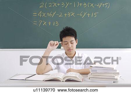 Stock Image - Teenager boy meditating with eyes closed. Fotosearch