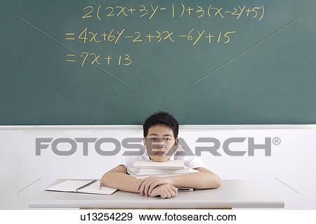 "Teenager boy sitting with a stack of books, portrait" View Large Photo Image Stock Photo - "Teenager boy sitting with a stack of books, portrait". Fotosearch