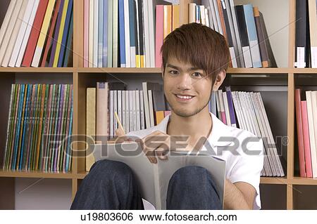"Teenager boy studying and looking at the camera, portrait" View Large Photo Image Stock Photograph - "Teenager boy studying and looking at the camera, portrait". Fotosearch