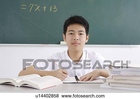 Stock Photo - "Teenager boy writing and studying, portrait". Fotosearch