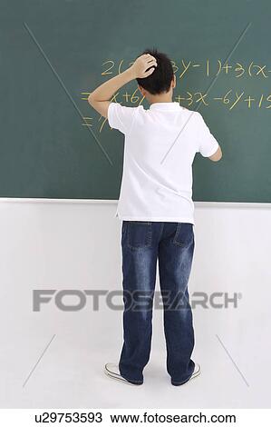 "Teenager boy writing on the blackboard, portrait" View Large Photo Image Stock Image - "Teenager boy writing on the blackboard, portrait". Fotosearch