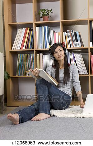 "Young girl reading book and listening music, portrait" View Large Photo Image Stock Image - "Young girl reading book and listening music, portrait". Fotosearch