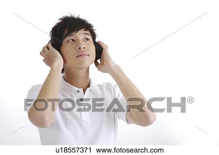"Young man listening music and looking up, portrait" View Large Photo Image Stock Image - "Young man listening music and looking up, portrait". Fotosearch