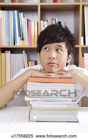 Young man looking away with head in hands View Large Photo Image Stock Photography - Young man looking away with head in hands. Fotosearch