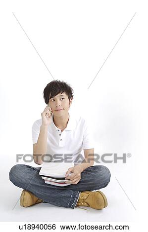 "Young man sitting and reading book, portrait" View Large Photo Image Stock Photograph - "Young man sitting and reading book, portrait". Fotosearch