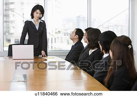 Business people having a meeting and discussing together View Large Photo Image Stock Photograph - Business people having a meeting and discussing together. Fotosearch