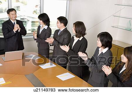 Business people standing in the office and clapping View Large Photo Image Stock Image - Business people standing in the office and clapping. Fotosearch