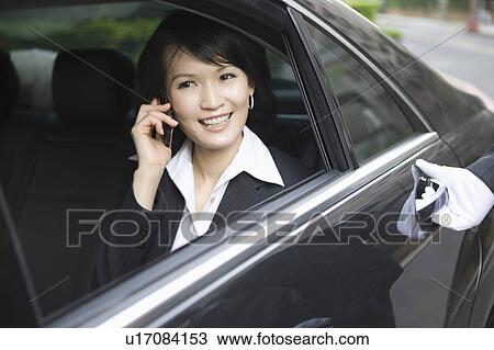 Business woman sitting in the car and on the phone View Large Photo Image Stock Image - Business woman sitting in the car and on the phone. Fotosearch