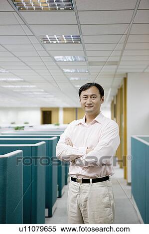 Stock Photography - "Businessman standing with hands on chest, portrait". Fotosearch