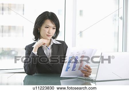 "Businesswoman reading report, portrait" View Large Photo Image Stock Image - "Businesswoman reading report, portrait". Fotosearch