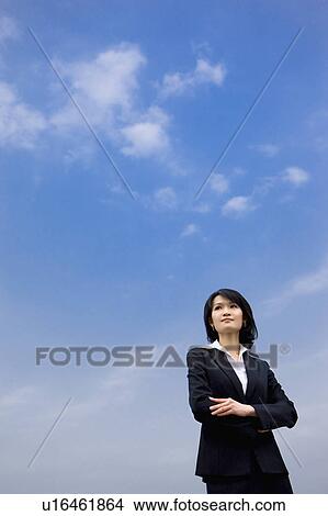 Businesswoman standing with hands on chest View Large Photo Image Picture - Businesswoman standing with hands on chest. Fotosearch
