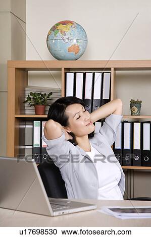 Businesswoman stretching for a rest and closing her eyes View Large Photo Image Stock Image - Businesswoman stretching for a rest and closing her eyes. Fotosearch