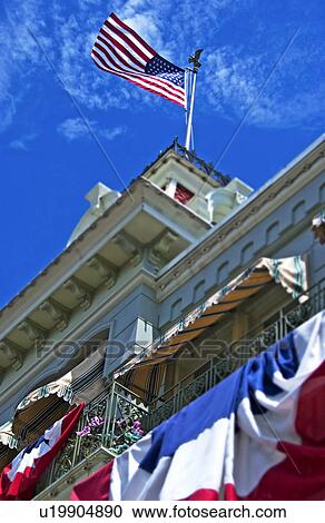Stock Image - US flag atop building. Fotosearch