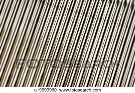 Stock Image - Metal pipe products in manufacturing plant. Fotosearch