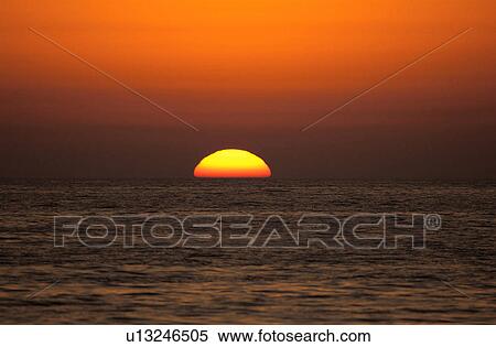 Sunset over the ocean View Large Photo Image Stock Photography - Sunset over the ocean. Fotosearch