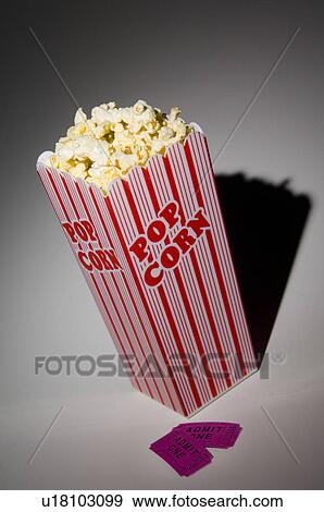 Stock Photo - Box of popcorn and movie ticket. Fotosearch