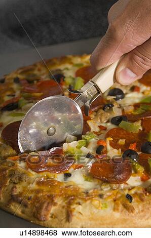 Man cutting pizza View Large Photo Image Stock Photo - Man cutting pizza. Fotosearch