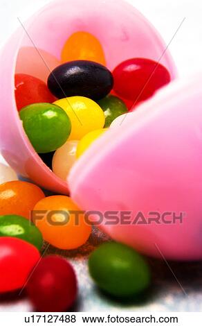 Plastic Easter egg w jelly beans View Large Photo Image Stock Photo - Plastic Easter egg w jelly beans. Fotosearch