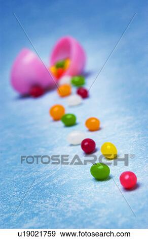 Plastic Easter egg with jelly beans View Large Photo Image Stock Photo - Plastic Easter egg with jelly beans. Fotosearch
