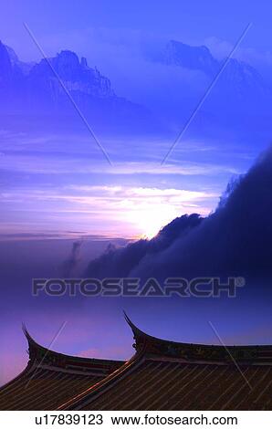 Drawing - Digitally generated image of Chinese-styled roofs in front of mountains in the horizon. Fotosearch