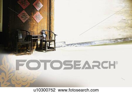 Digitally generated image, two wooden chairs and a table in front of an old house, with a Chinese-styled pattern in the corner View Large Illustration Drawing - Digitally generated image, two wooden chairs and a table in front of an old house, with a Chinese-styled pattern in the corner. Fotosearch