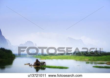 Small shed in the middle of a lake, surrounded by mountains, grass, and trees View Large Illustration Clip Art - Small shed in the middle of a lake, surrounded by mountains, grass, and trees. Fotosearch