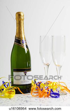 Picture - Champagne bottle with champagne flutes. Fotosearch