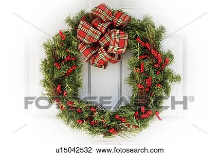 Stock Image - Christmas wreath on door. Fotosearch
