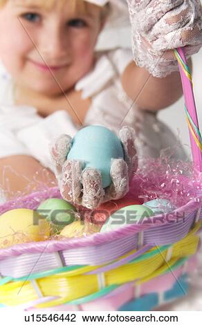 Girl picking eggs from basket View Large Photo Image Stock Image - Girl picking eggs from basket. Fotosearch