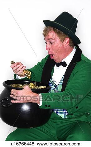 Stock Photo - Man dressed as Leprechaun with pot of gold. Fotosearch