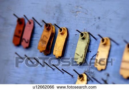 Stock Photograph - Hanging tags in factory setting. Fotosearch
