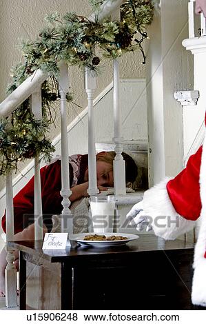 Stock Photo - Child sleeping during Santas visit. Fotosearch