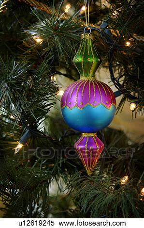 Stock Photography - Ornament hanging on Christmas tree. Fotosearch