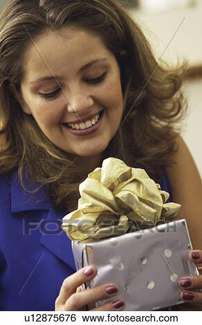 Stock Photograph - Woman holding gift. Fotosearch