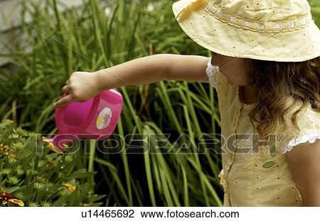 Little girl watering flowers View Large Photo Image Stock Image - Little girl watering flowers. Fotosearch