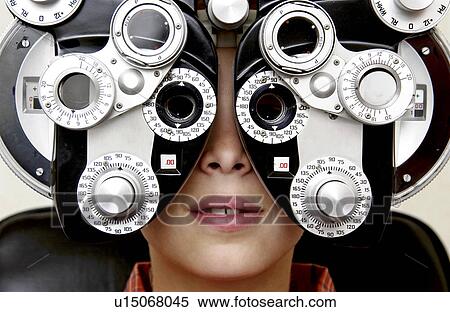 Boy getting eye exam View Large Photo Image Stock Photography - Boy getting eye exam. Fotosearch