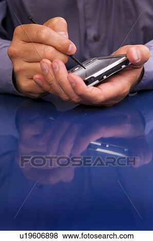 Stock Photo - Businessman using PDA. Fotosearch