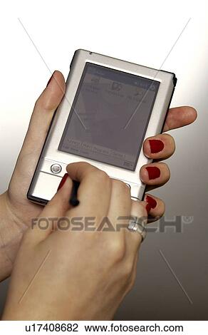 Stock Image - Businesswoman with PDA. Fotosearch