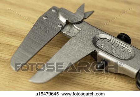 Stock Photography - Caliper on wood . Fotosearch