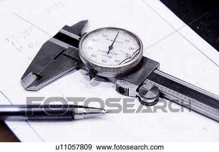 Stock Photo - Caliper pen and pad on work table. Fotosearch